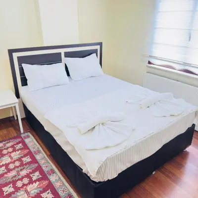 a large bed with white sheets and white pillows at Sophia bukalemoon apartment in Istanbul