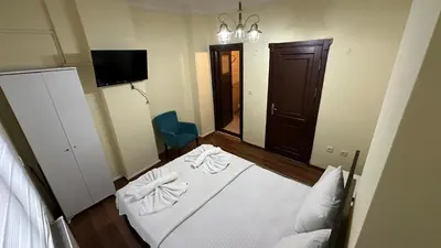 a small bedroom with a bed and a mirror at Sophia bukalemoon apartment in Istanbul