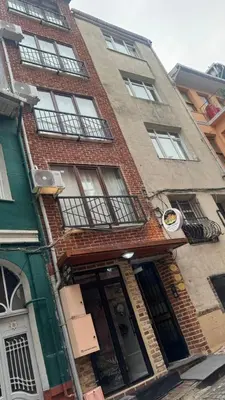 a tall brick building with windows and a door at balatlifesuites in Istanbul