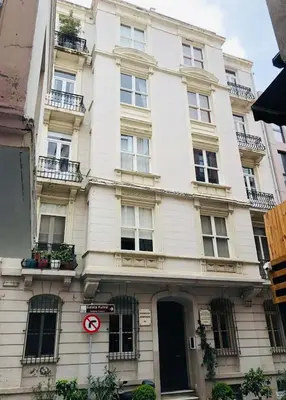 a white building with a no parking sign in front of it at A Modernized Apt In The Historic Area Of Istanbul in Istanbul