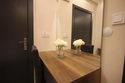 a table with two vases with white flowers on it at Linada Hotel Taksim in Istanbul