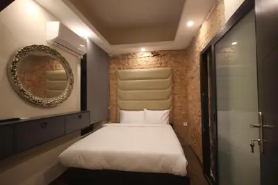 a small bedroom with a bed and a mirror at Linada Hotel Taksim in Istanbul