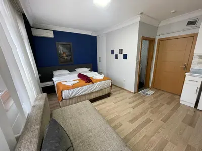 a bedroom with two beds and a blue wall at Taxim Filia Apart in Istanbul