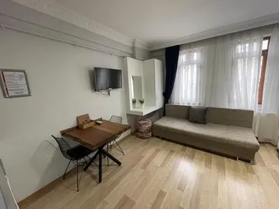 a living room with a couch and a table at Taxim Filia Apart in Istanbul