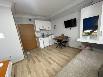 a small apartment with a kitchen and a table at Taxim Filia Apart in Istanbul