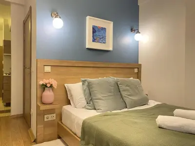 a bedroom with a bed with a vase of flowers at SIM Crown Hotel in Istanbul