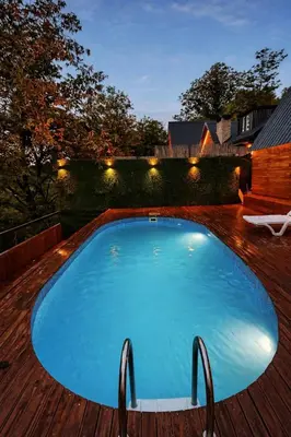 a large blue swimming pool on a wooden deck at Alyüz Bungalov in Sapanca