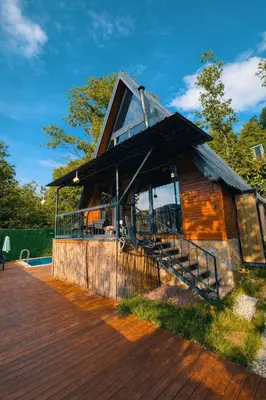 a house with a large window and a wooden deck at Alyüz Bungalov in Sapanca