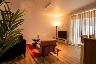 a living room with a chair and a television at Trendy 2BD Cozy Modern Bebek Home! #415 in Istanbul