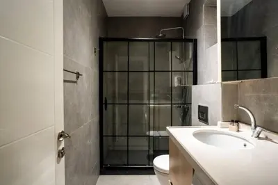 a bathroom with a toilet and a sink and a shower at Trendy 2BD Cozy Modern Bebek Home! #415 in Istanbul