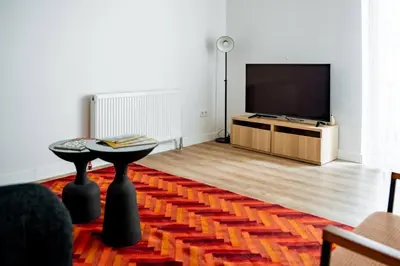 a living room with a flat screen tv and a table at Trendy 2BD Cozy Modern Bebek Home! #415 in Istanbul
