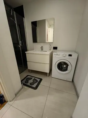 a bathroom with a washing machine and a sink at Apartment at Prime Istanbul in Istanbul