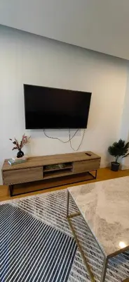 a living room with a flat screen tv on a wall at Apartment at Prime Istanbul in Istanbul