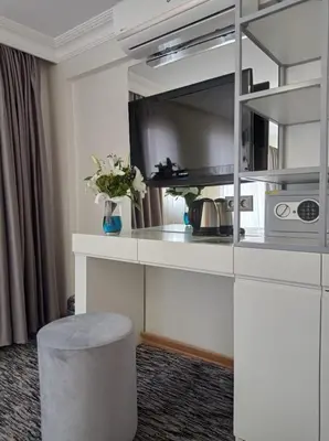 a kitchen with a counter and a stool in a room at Turk Art Hotel in Istanbul