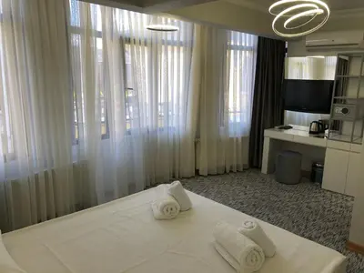 a bedroom with two towels on a bed with windows at Turk Art Hotel in Istanbul