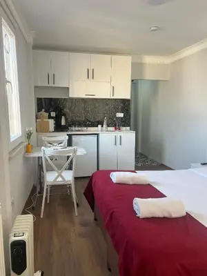 a kitchen with two beds in a room at Balat Life Suites in Istanbul
