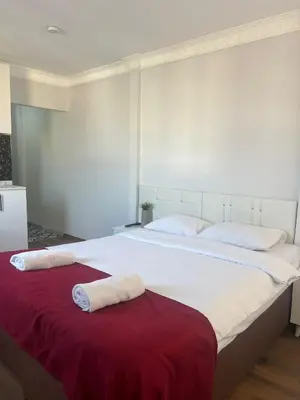 a large white bed with two towels on it at Balat Life Suites in Istanbul