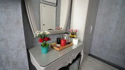 a table with flowers on it with a mirror at Old City Viva Hotel in Istanbul