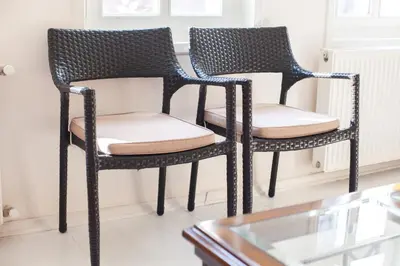 two black wicker chairs sitting next to a table at Newly-renovated apartment 1 in Istanbul
