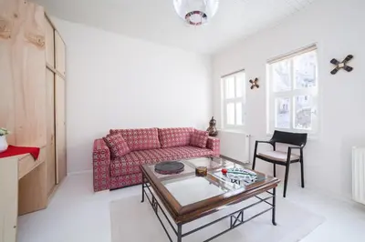 a living room with a red couch and a table at Newly-renovated apartment 1 in Istanbul