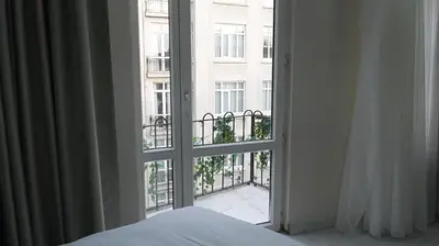 a bedroom window with a view of a building at Taksim Armoni Hotel in Istanbul