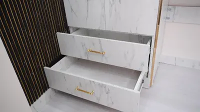 a bathroom with three white drawers with gold handles at Taksim Armoni Hotel in Istanbul