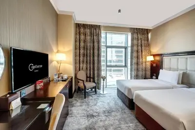 a hotel room with two beds and a flat screen tv at Elma hotel in Istanbul