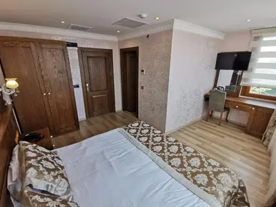 a bedroom with a bed and a desk at Perapolis Hotel in Istanbul