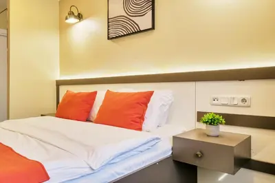 a bedroom with a bed with orange and white pillows at Duck Hotel in Istanbul