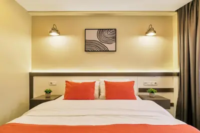 a bedroom with a bed with orange pillows at Duck Hotel in Istanbul