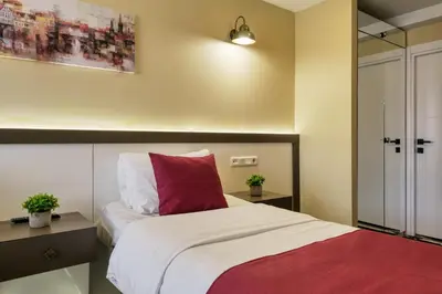a bedroom with a bed with a red pillow at Duck Hotel in Istanbul