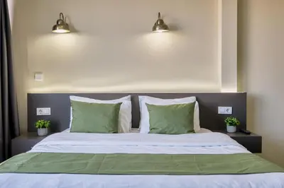a bedroom with a bed with two green pillows at Duck Hotel in Istanbul