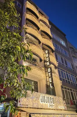 a building with a sign on the side of it at Duck Hotel in Istanbul