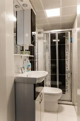a bathroom with a white sink and a toilet at Taksm Mood in Istanbul
