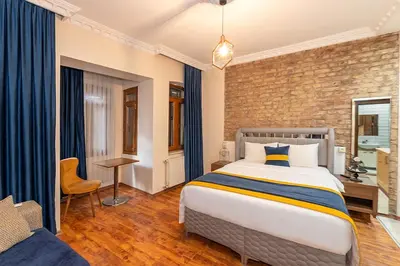 a bedroom with a bed and a brick wall at Opêra house taksim in Istanbul