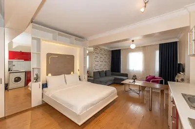 a bedroom with a large bed and a living room at Opêra house taksim in Istanbul