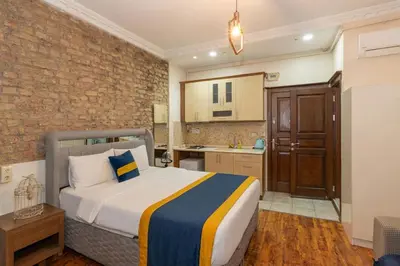 a bedroom with a bed and a kitchen at Opêra house taksim in Istanbul