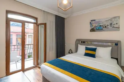 a bedroom with a bed and a balcony at Opêra house taksim in Istanbul