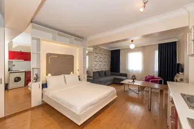 a bedroom with a large bed and a living room at Opêra house taksim in Istanbul