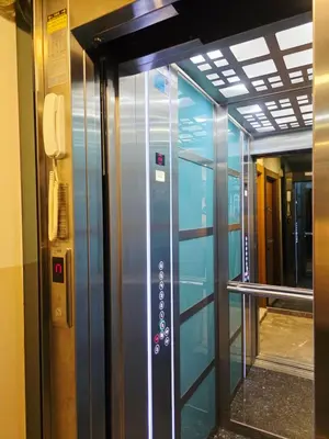 a glass elevator in a building with a phone at Birru Suites in Istanbul