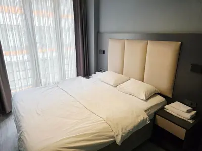 a bedroom with a large white bed with a window at Birru Suites in Istanbul
