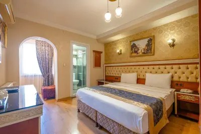 a hotel room with a bed and a bathroom at Big Apple hotel istanbul in Istanbul