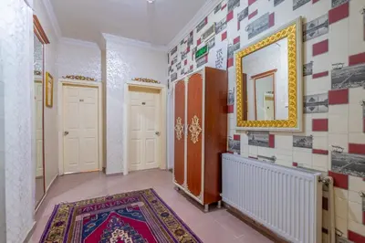 a hallway with a mirror and a rug at Big Apple hotel istanbul in Istanbul