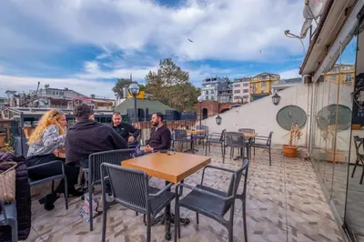 a group of people sitting at a table on a patio at Big Apple hotel istanbul in Istanbul