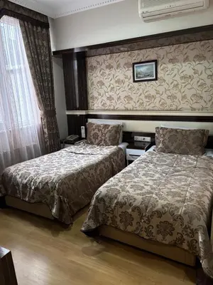a hotel room with two beds and a window at ESEN PALAS otel in Istanbul