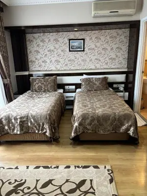 a bedroom with two beds and a wall at ESEN PALAS otel in Istanbul