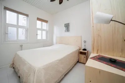a white bedroom with a bed and a lamp at Newly-renovated apartment 2 in Istanbul
