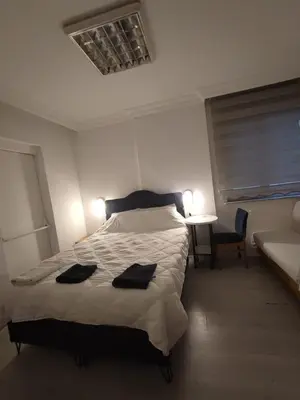 a bedroom with a bed with two black towels on it at Üsküdar Sahil Konaklama in Istanbul