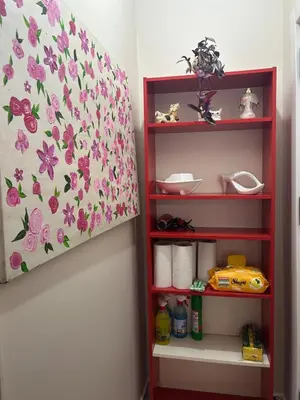 a bedroom with a bed with a floral bedspread at Bohemian Antique House in Colorful Balat in Istanbul