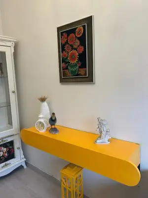 a yellow shelf on a wall with a picture at Bohemian Antique House in Colorful Balat in Istanbul